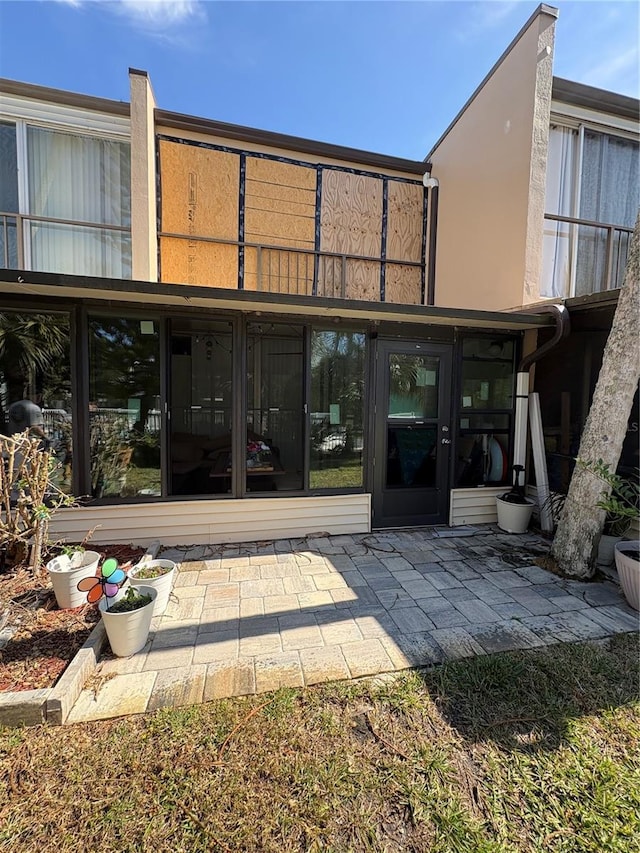 rear view of property featuring a patio area