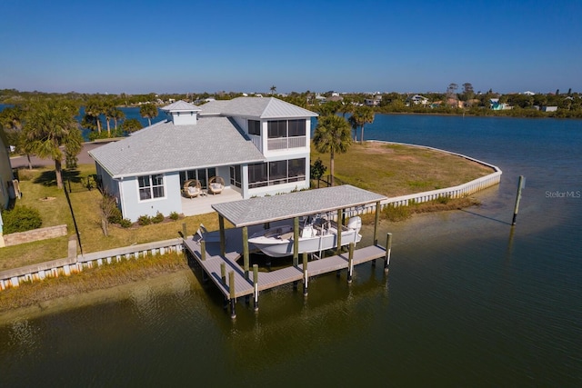 view of dock featuring a water view and a lawn