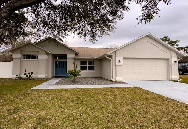 ranch-style home featuring a garage and a front lawn