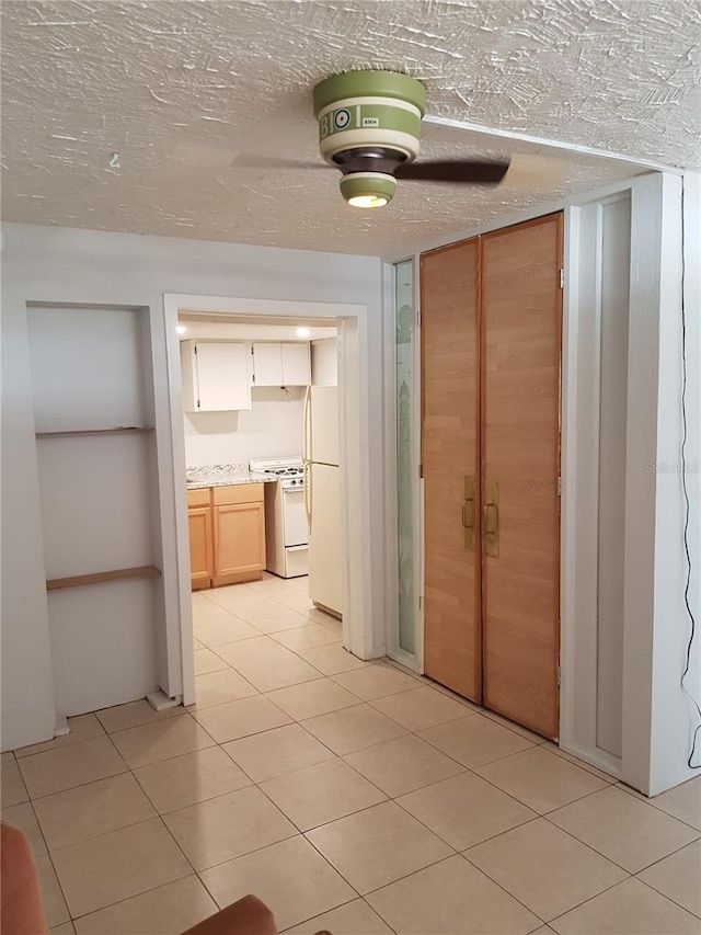 hallway featuring light tile patterned floors