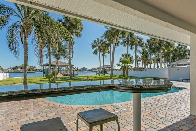 view of swimming pool with a gazebo, a water view, and a patio