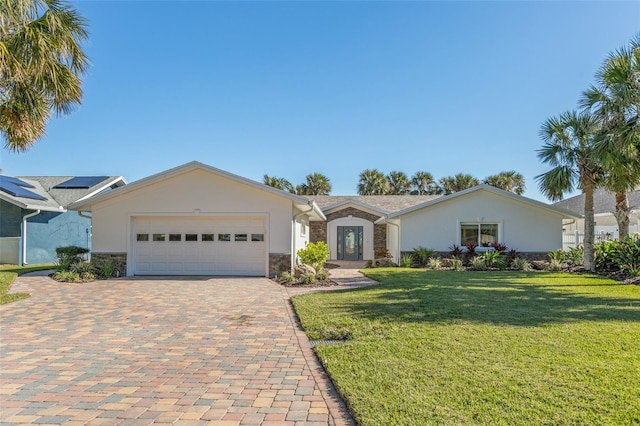 single story home featuring a garage and a front lawn