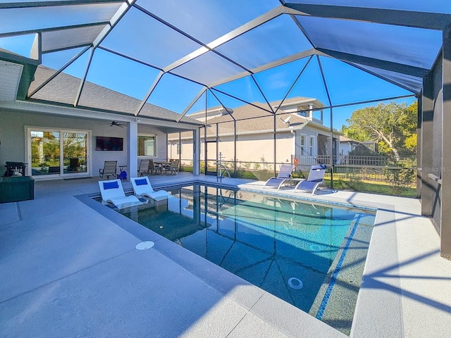 view of swimming pool featuring a lanai, a patio area, and ceiling fan