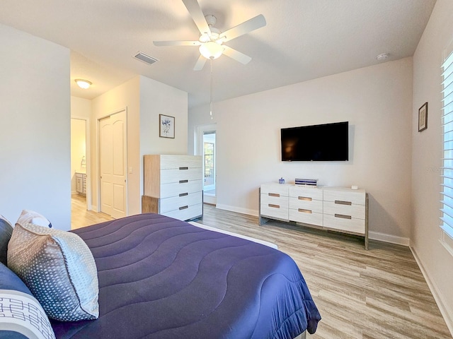 bedroom featuring connected bathroom, ceiling fan, and light hardwood / wood-style flooring