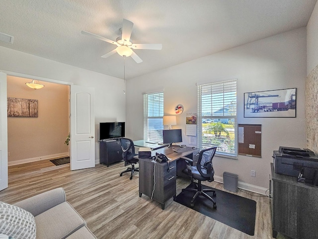 office with ceiling fan, a textured ceiling, and light hardwood / wood-style floors