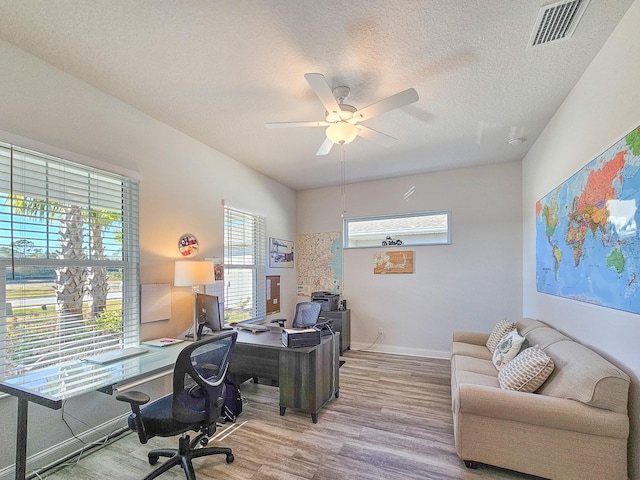 office with ceiling fan, wood-type flooring, and a textured ceiling