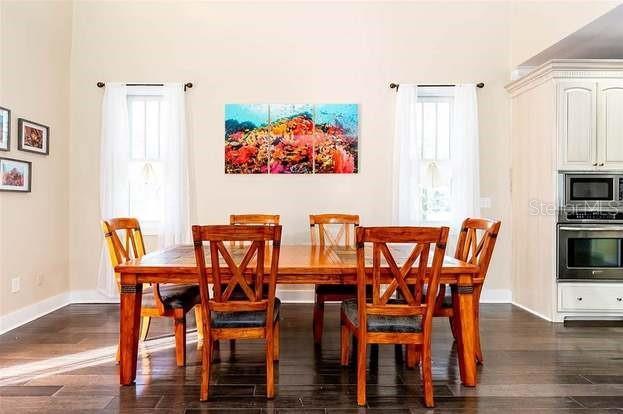 dining room with a wealth of natural light and dark hardwood / wood-style flooring