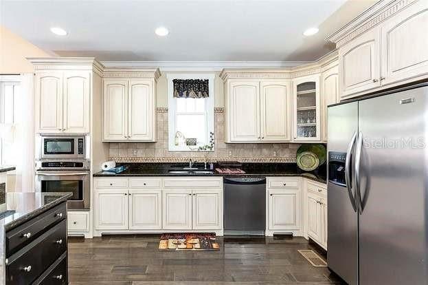 kitchen featuring sink, cream cabinets, appliances with stainless steel finishes, and backsplash