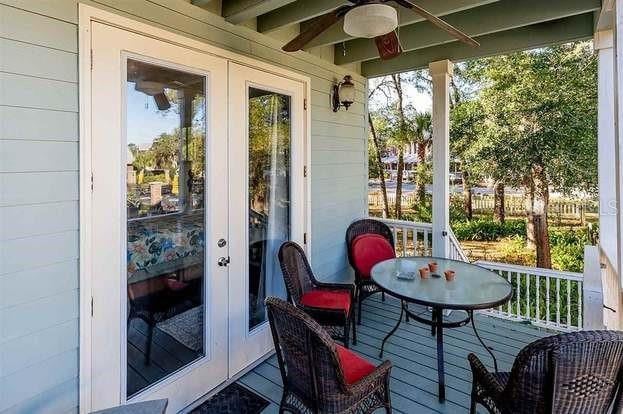 sunroom / solarium with ceiling fan and french doors