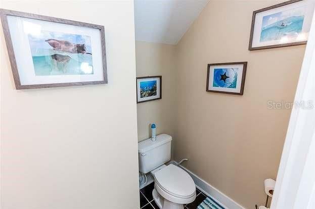 bathroom with toilet and tile patterned flooring