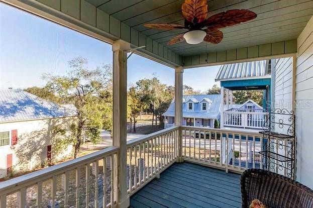 wooden deck featuring ceiling fan