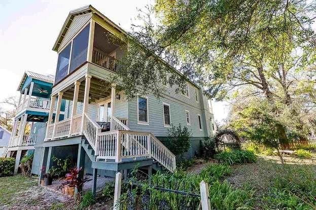 back of house with a balcony and a sunroom