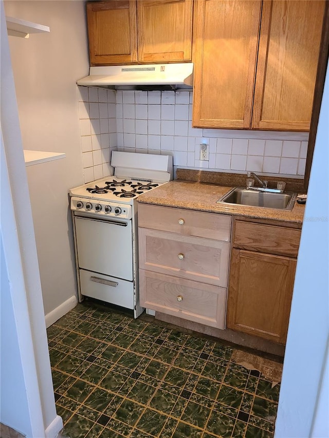 kitchen with sink, white range with gas cooktop, and tasteful backsplash