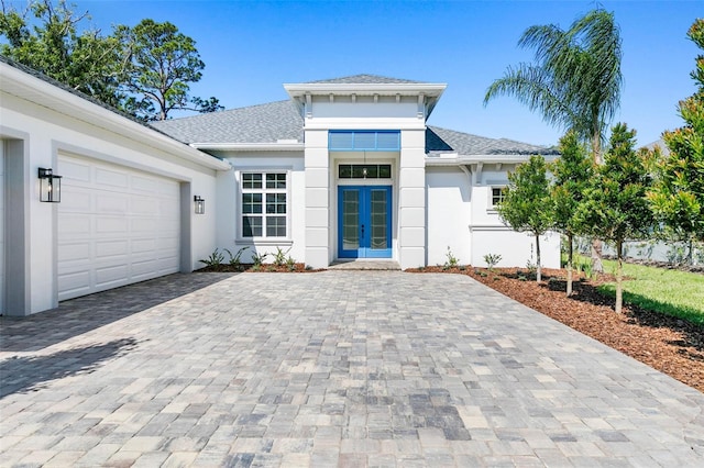 view of front of house featuring a garage and french doors