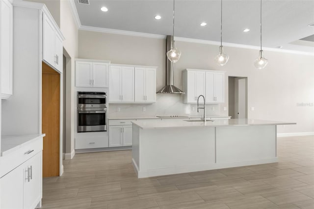 kitchen featuring light countertops, white cabinets, a sink, and decorative backsplash