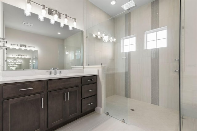 full bath with tile patterned floors, visible vents, vanity, and walk in shower