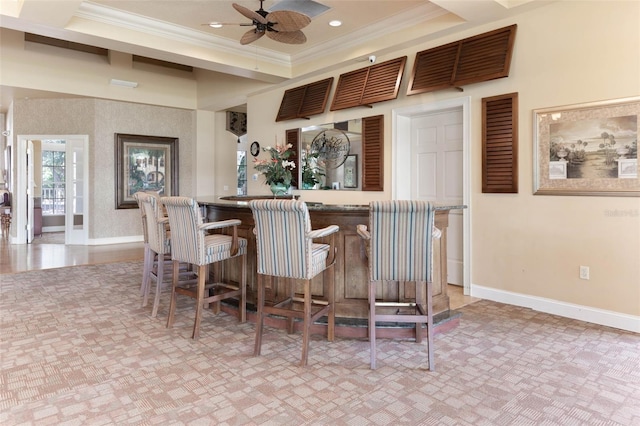 bar featuring a bar, baseboards, crown molding, and recessed lighting