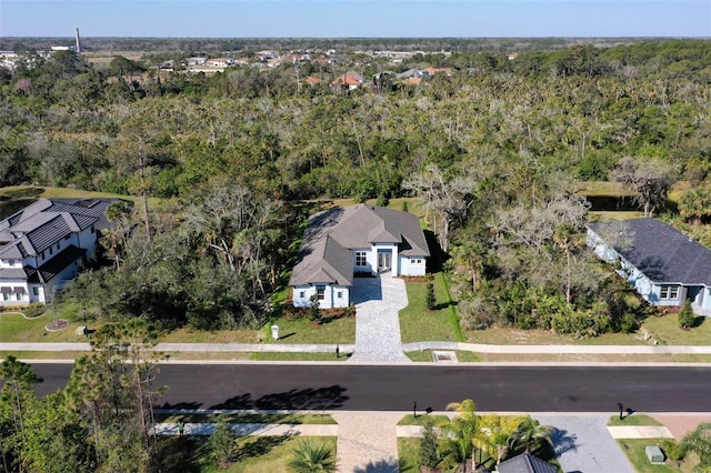 drone / aerial view featuring a forest view