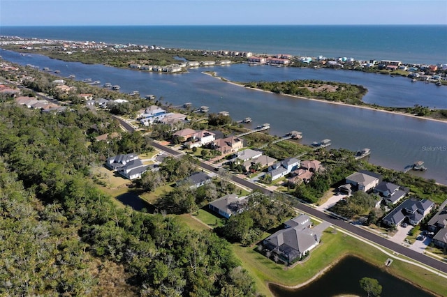 drone / aerial view featuring a residential view and a water view