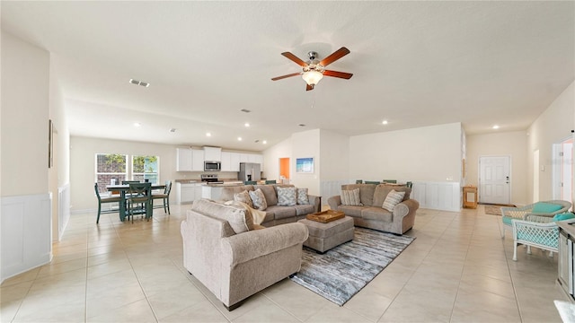 tiled living room featuring ceiling fan