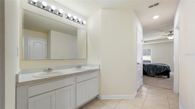 bathroom featuring vanity, ceiling fan, tile patterned floors, and a textured ceiling