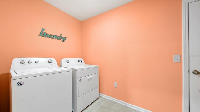 laundry room featuring independent washer and dryer and light tile patterned flooring