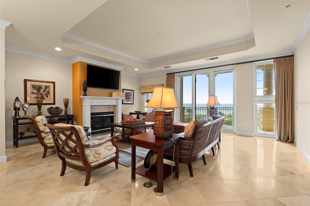 sitting room with baseboards, visible vents, a tray ceiling, crown molding, and a fireplace