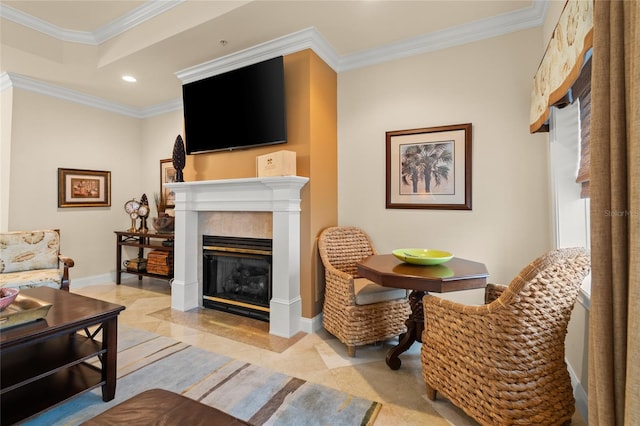 living area featuring recessed lighting, baseboards, crown molding, and a glass covered fireplace