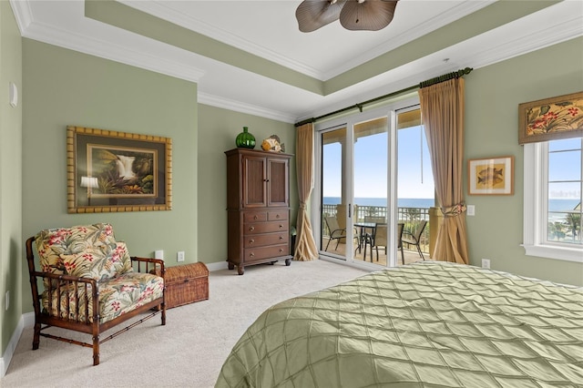 bedroom featuring ornamental molding, access to outside, a tray ceiling, and light colored carpet