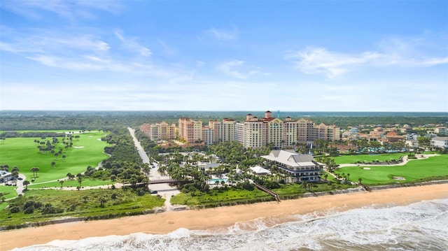 drone / aerial view with a water view, a view of the beach, and a city view