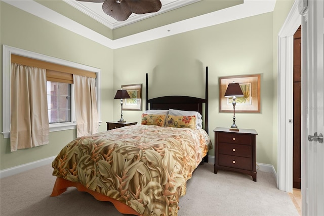 carpeted bedroom featuring baseboards, ornamental molding, and ceiling fan