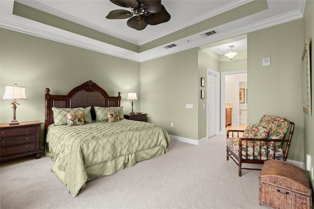 bedroom featuring a tray ceiling, visible vents, crown molding, and light carpet