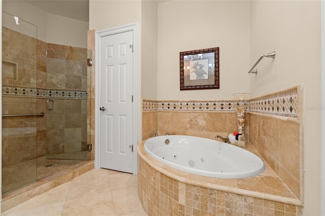 full bathroom featuring a stall shower, tile patterned flooring, and a jetted tub