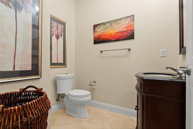 bathroom with toilet, tile patterned flooring, baseboards, and vanity