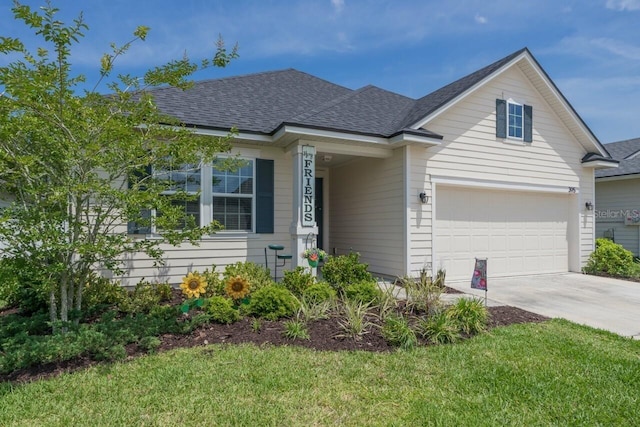 view of front of property with a garage and a front lawn