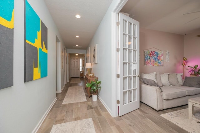 hallway with light hardwood / wood-style flooring