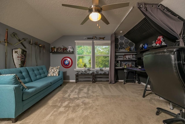 carpeted home office with ceiling fan, a textured ceiling, and lofted ceiling