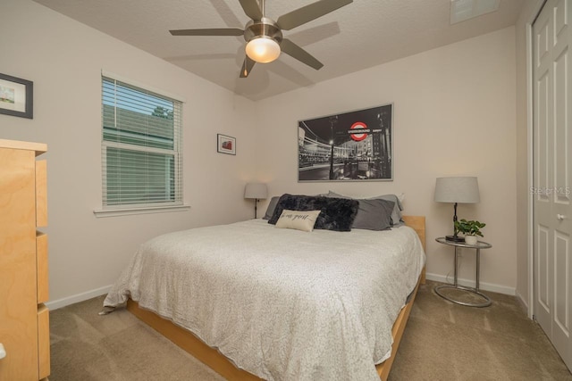 carpeted bedroom with a closet and ceiling fan