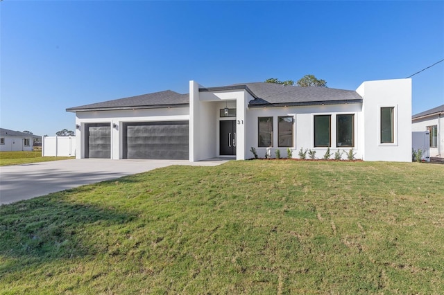 view of front of home with a garage and a front yard