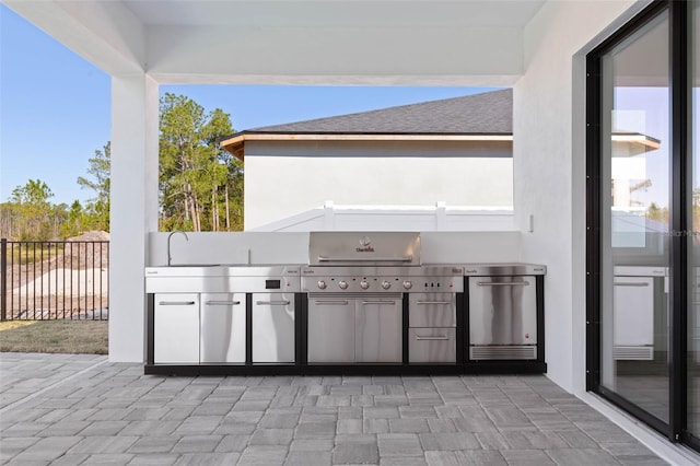 view of patio / terrace with grilling area and an outdoor kitchen