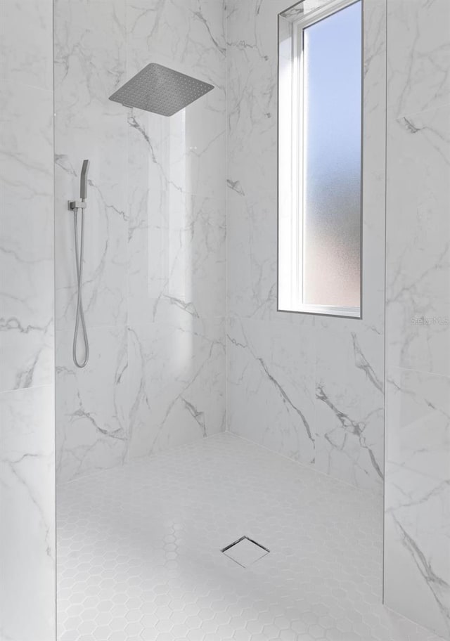 interior details with a tile shower