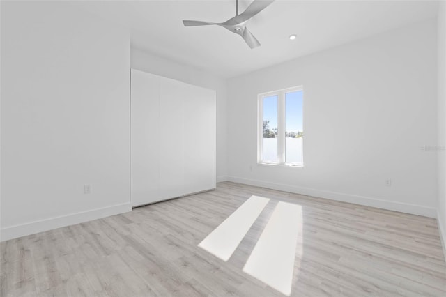 empty room featuring ceiling fan and light hardwood / wood-style flooring