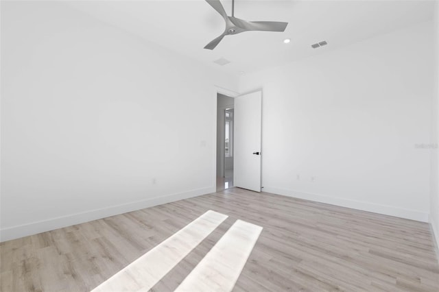 empty room with ceiling fan and light wood-type flooring