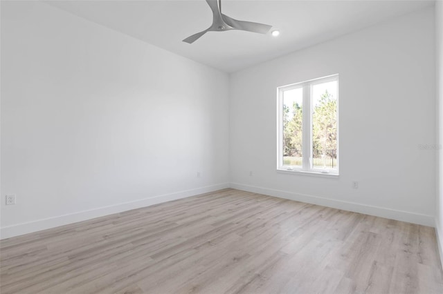 empty room with ceiling fan and light wood-type flooring