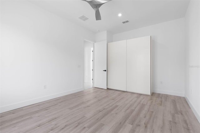 unfurnished bedroom featuring ceiling fan and light hardwood / wood-style flooring