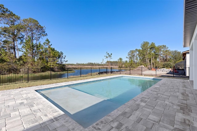 view of swimming pool with a water view and a patio