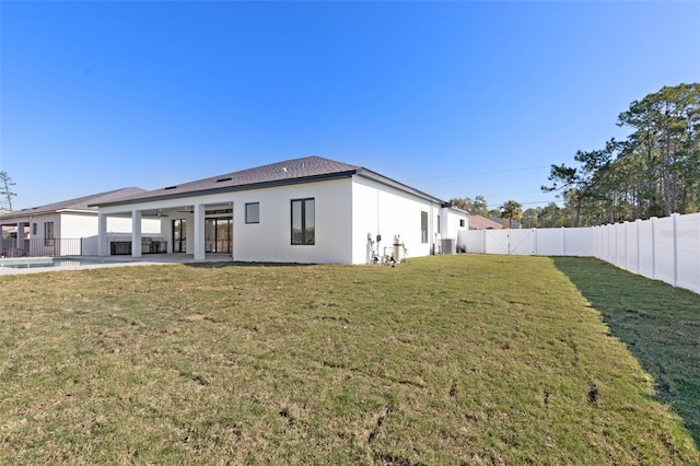 back of property featuring a lawn and a patio area