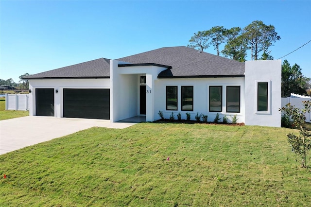 view of front facade with a garage and a front lawn