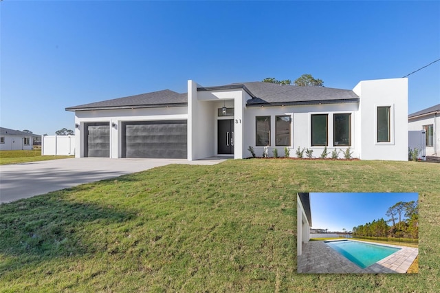 view of front of property with a garage and a front lawn