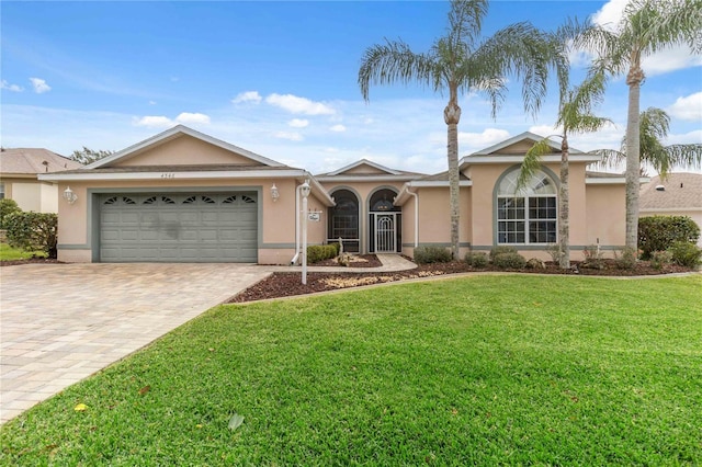 single story home with a front yard and a garage